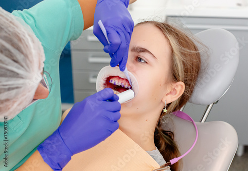 Concept of dental care. The process of installing orthodontic ceramic brackets.