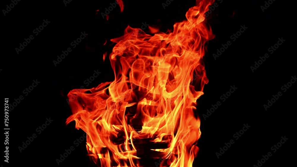 High pile of wood burns in the campfire. Timber burning in the bonfire at night isolated. High pile of wood burns in the campfire. Timber burning in the bonfire at night isolated.