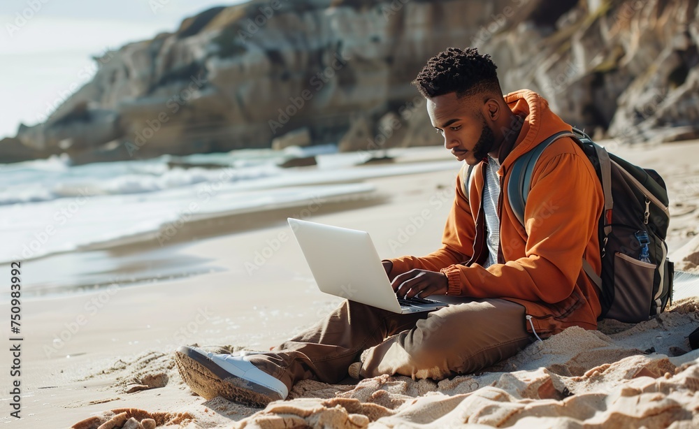 Person working on laptop at the beach