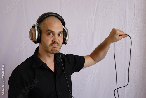 baldman wearing headphones , music listening and funny expressions photo