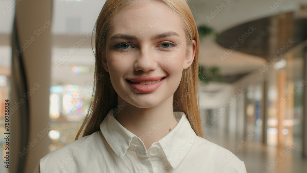 Close up portrait smiling Caucasian girl woman 20s young gen z lady shop assistant manager office worker female entrepreneur employee shopper consumer customer feminine client posing in shopping mall