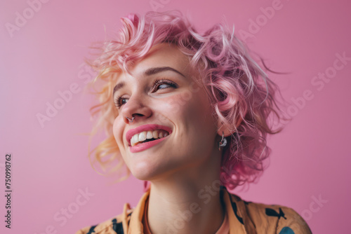 Happy Young Woman with Curly Hair and Trendy Make-Up Posing in a Stylish Studio, Against a Bright Pink Background