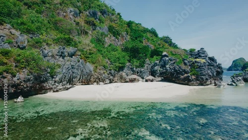 Aerial view 4k drone shot of small islands and beaches around Calauit National park Coron island, the Philippines. Crystal clear turquoise blue waters, palm tree lined white sandy beaches, and visible photo