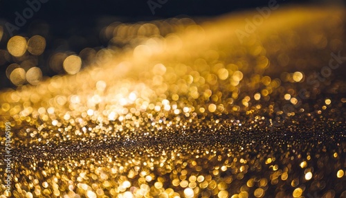 background of abstract glitter lights gold and black de focused