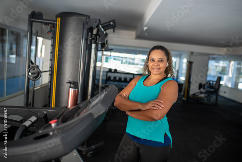 Sporty woman exercising on multistation at gym . Fitness exercising in gym