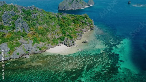 Aerial view 4k drone shot of small islands and beaches around Calauit National park Coron island, the Philippines. Crystal clear turquoise blue waters, palm tree lined white sandy beaches, and visible photo