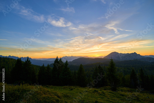 A beautiful sunset in the Alpine mountains. Forest, Alpine peaks, Austria, Europe.