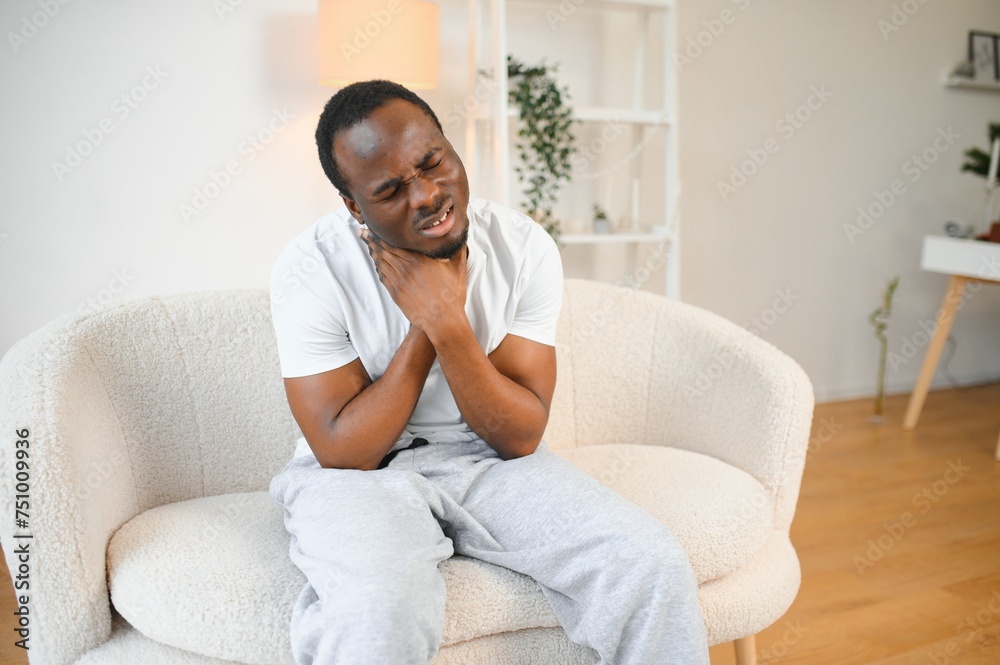 Sad black guy suffering from sore throat, touching highlighted neck, copy space Sad black guy suffering from sore throat, touching highlighted neck, copy space