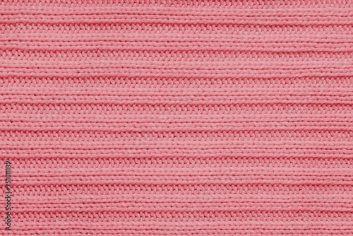 Jersey textile background , red striped knitted fabric. Woolen knitwear, sweater, pullover surface texture, textile structure, cloth surface, weaving of knitwear material. Wallpaper, backdrop.