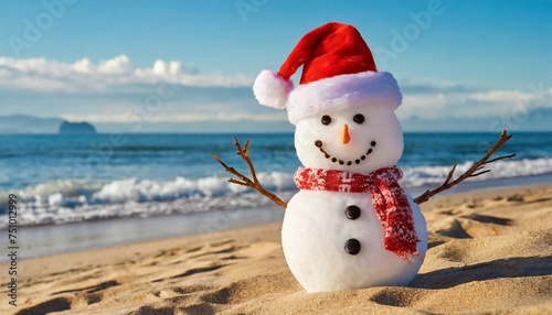 christmas snowman in santa hat at sandy beach