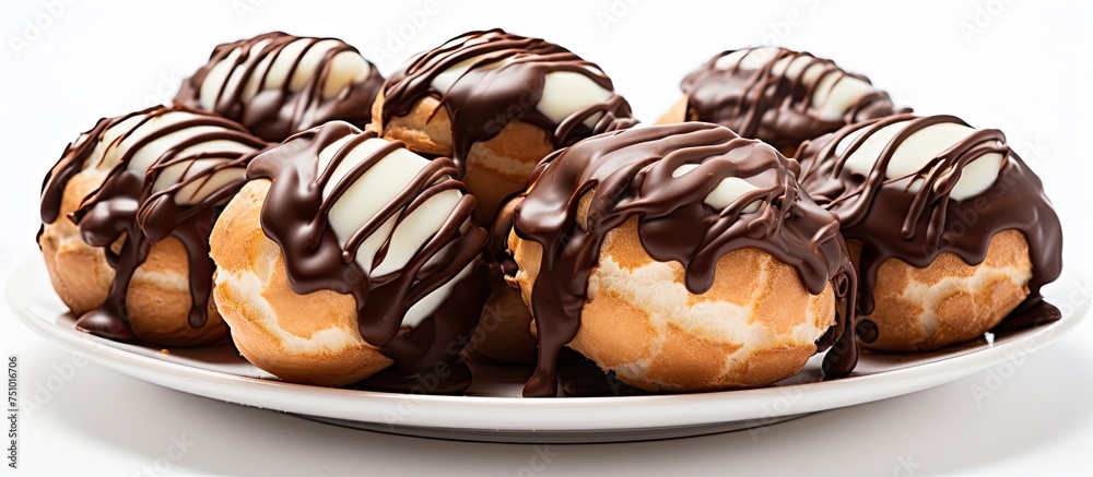 A white plate is shown with multiple chocolate covered donuts neatly arranged on top. The donuts appear freshly made and are coated in a rich layer of chocolate. The contrasting colors of the white