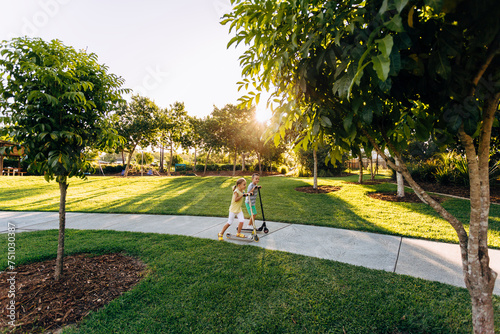 Children playing on scooters in park