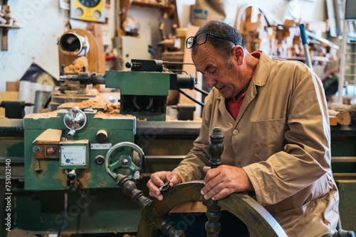 Craftsman sanding wooden steering wheel photo