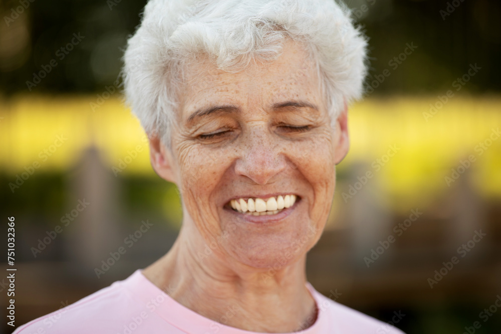 Pretty elderly woman smiling in the park Pretty elderly woman smiling in the park