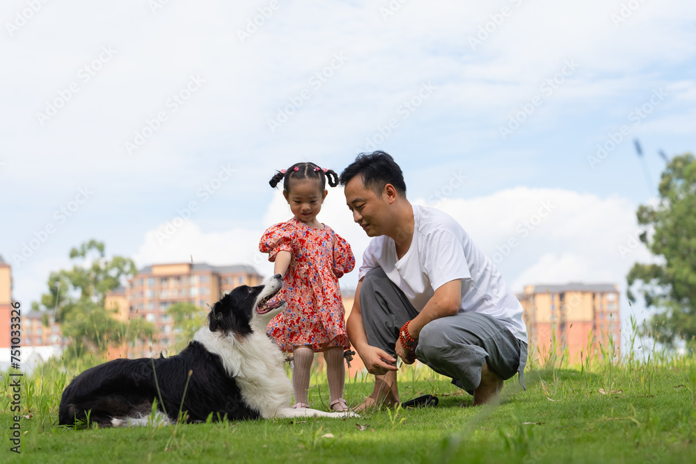 happy asian man with daughter and dog in the park happy asian man with daughter and dog in the park