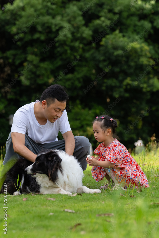 happy asian man with daughter and dog in the park happy asian man with daughter and dog in the park