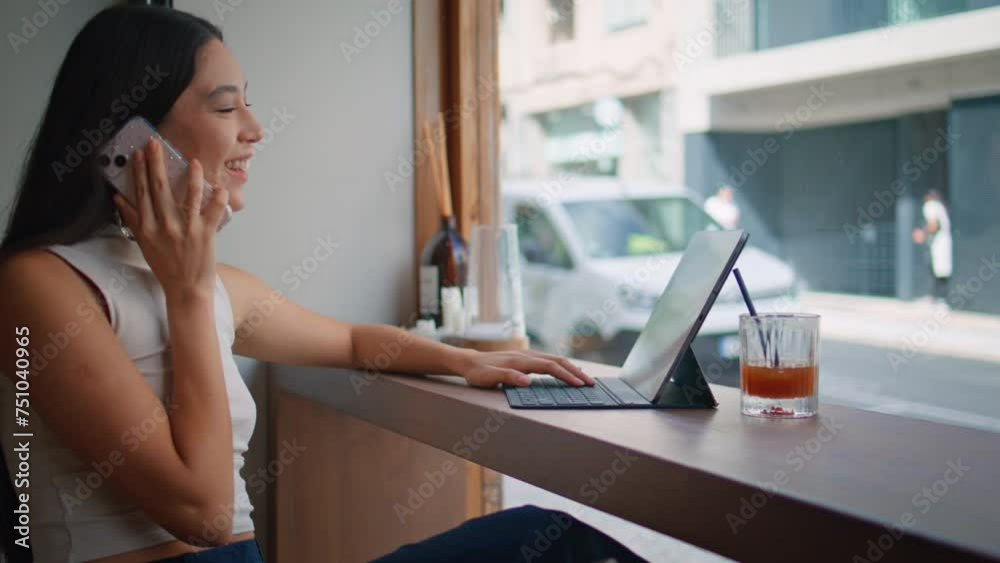 Chinese girl making call choosing purchases on laptop at coffeeshop close up. Chinese girl making call choosing purchases on laptop at coffeeshop close up.