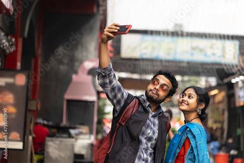 Indian Couple Taking Selfie And Enjoying At Outdoors In Daytime photo