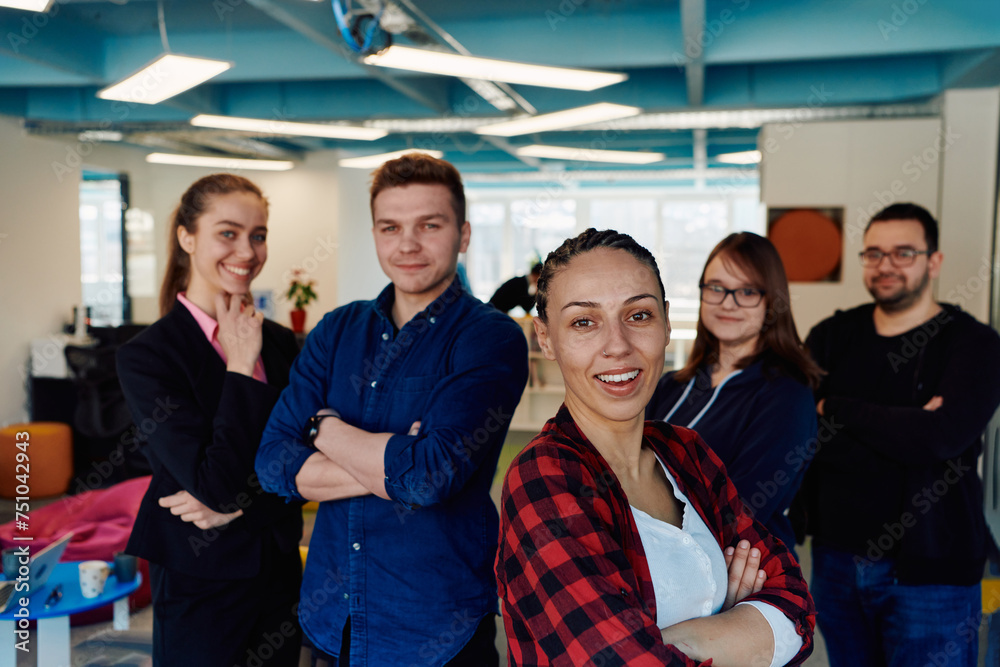 Obraz premium Portrait of a successful creative businessman and businesswoman looking at camera and smiling. Diverse business people standing together at startup.
