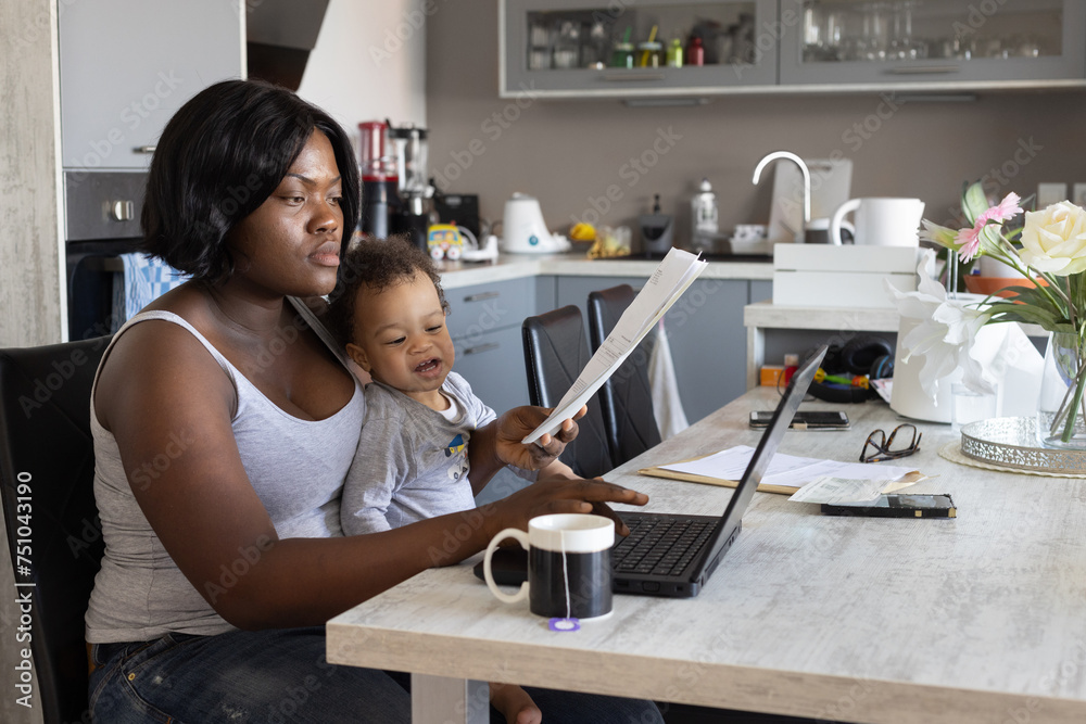 mother working from home with baby child on her lap