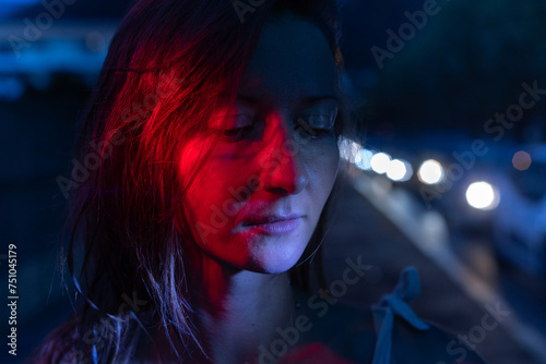 sad woman in night city, mental health concept, closeup photo
