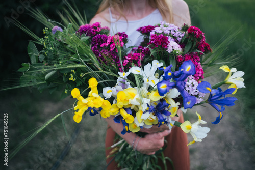 Woman holding bouquet of flowers photo