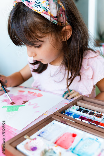 Little Girl Painting and drawing with Watercolor photo