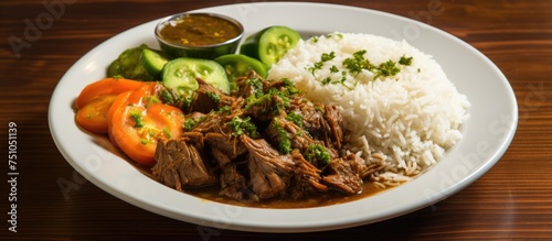 A white plate is presented with a serving of basmati rice, vegetables, and beef. The dish also includes Mulukhiyah soup as a flavorful addition.