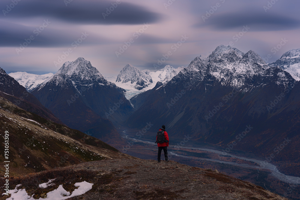 Solo traveler overlooking glacier valley in the Alaska wilderness. Solo traveler overlooking glacier valley in the Alaska wilderness.