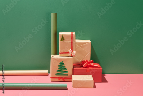 Christmas wrapped gift boxes on pink table background photo