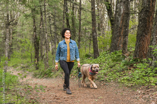 Woman walking her dog in nature photo