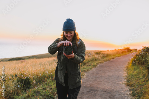 Woman Holding Camera Outdoors photo