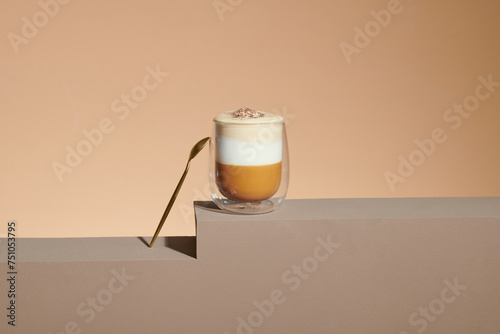 Cafe latte macchiato layered coffee in a see through glass coffee cup. photo