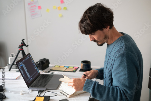 A man working on a laptop from home photo