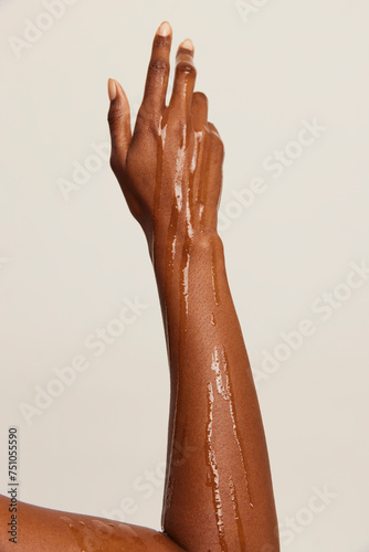 Oil dripping down woman's arm photo