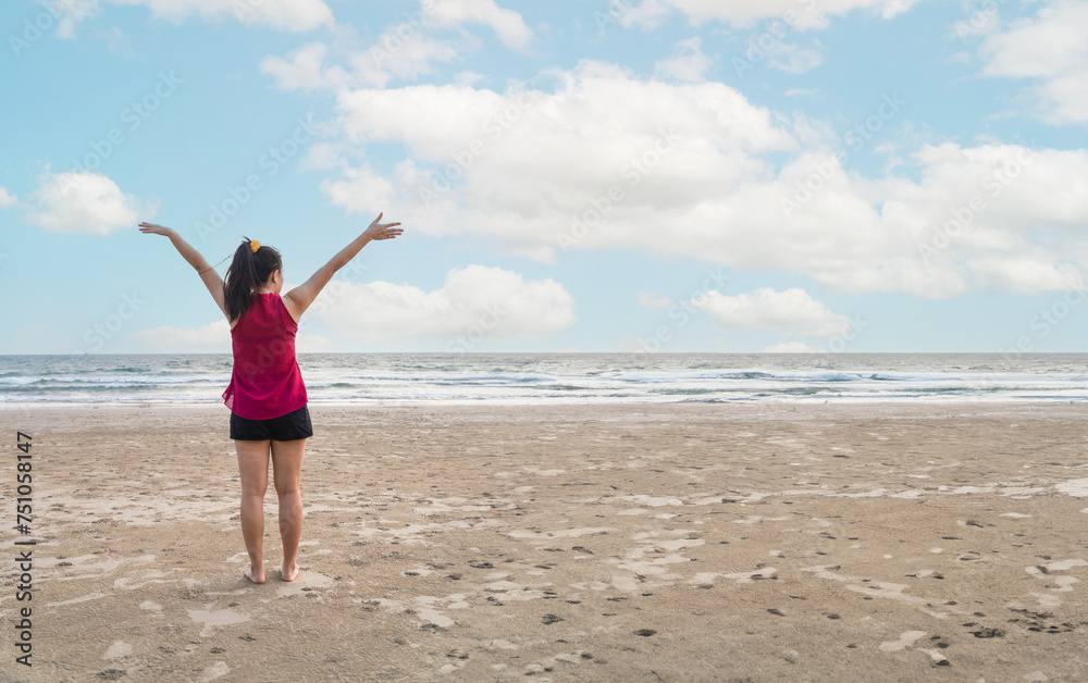 Summer beach vacation concept, happy woman raising hands up on sea beach background. Summer beach vacation concept, happy woman raising hands up on sea beach background.