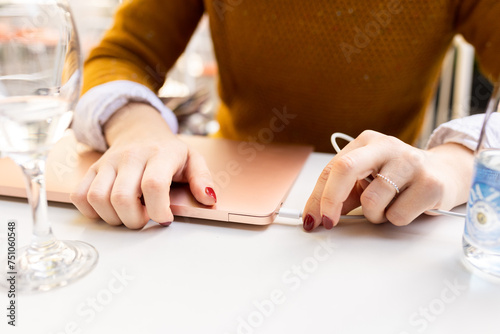 Business woman plugging laptop photo
