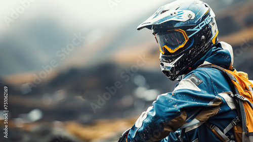 A motorcycle rider in protective gear overlooks misty mountain terrain © Татьяна Макарова