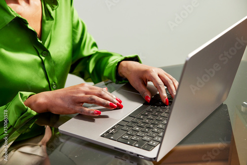 Cropped image of businesswoman working on netbook at office photo