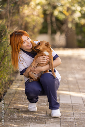 Caregiver caressing a therapy dog in the residence