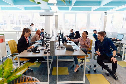 Wallpaper Mural Collaborative process of multicultural skilled young business team during brainstorming meeting in office.Diverse group of young people dressed in formal wear cooperating on developing design project Torontodigital.ca