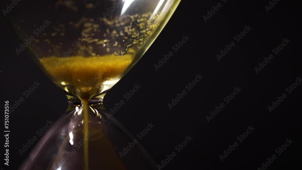Close up of hourglass sand timer time running out concept 17