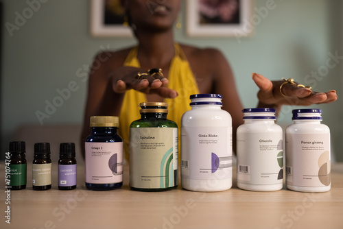Crop black female talking about dietary supplements photo