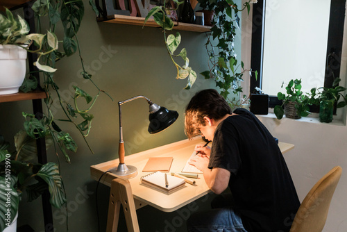 Young Man studies in his room photo