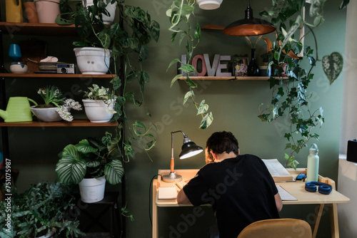 Young Man studies in his room photo