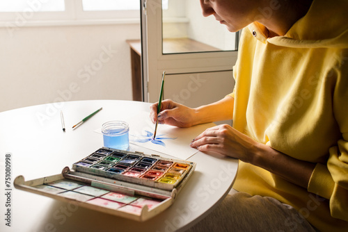 Woman drawing an illustration using a brush  photo