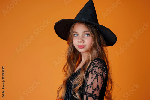 Beautiful little girl in witch costume and black hat on isolated background