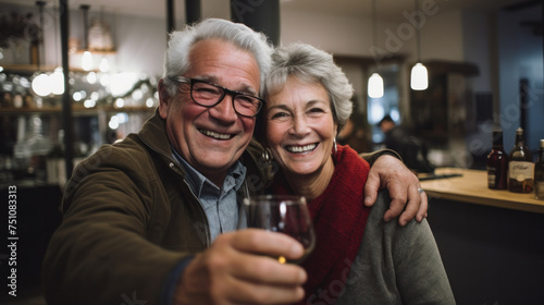 Mature couple having fun drinking beer at cafe bar restaurant - Husband and wife hanging out enjoying happy hour at brewery pub