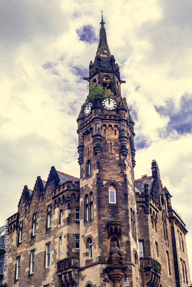 Behold the commanding presence of Glasgow's urban landscape with this captivating photo featuring a tall building crowned by a majestic clock tower.