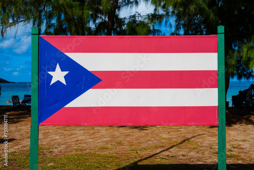 Puerto Rican flag painted on a wood board on the beach photo